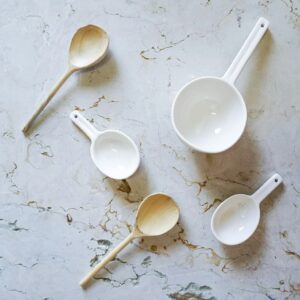 Ceramic and wooden spoons on a counter